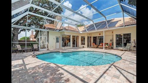 a swimming pool in a house with a glass ceiling at Beautiful Quiet Studio!! in Sarasota