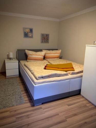 a bedroom with a bed with a blue mattress at Ferienwohnung Lorenz in Korswandt