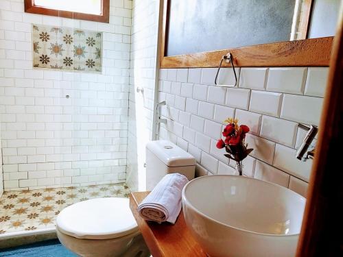 a bathroom with a tub and a toilet and a sink at Pousada Verde & Rio Lumiar in Lumiar