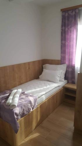 a bed with a wooden frame in a room at Villa Bunski biser in Blagaj