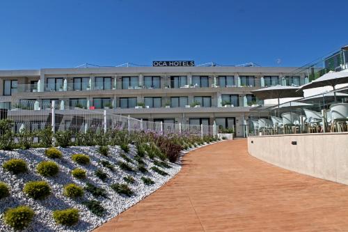 a large building with a large clock on the side of it at Oca Playa de Foz Hotel&Spa in Foz