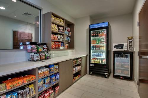 a grocery store aisle with a refrigerator at Holiday Inn Express & Suites Lancaster East - Strasburg by IHG in Strasburg