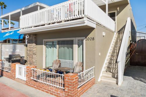 a house with two chairs and a balcony at Newport Vacation Memories in Newport Beach