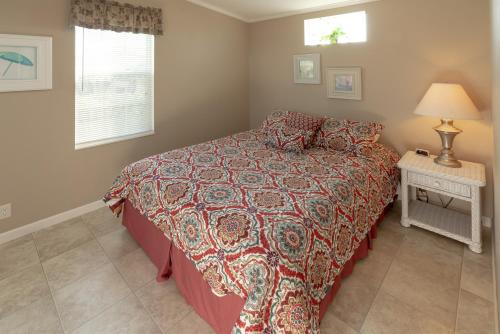 a bedroom with a bed and a table with a lamp at Buttonwood Bay in Sebring