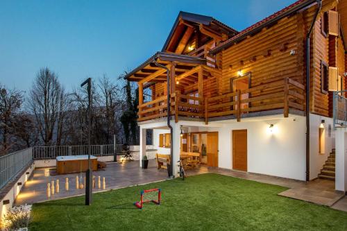 a house with a large deck with a yard at Mountain family home Nola Ivano in Delnice