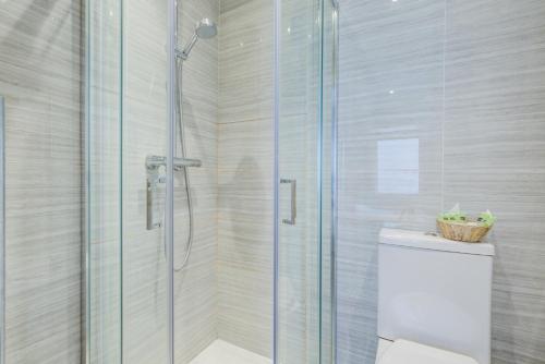 a bathroom with a shower stall and a toilet at Admiral Hotel at Park Avenue in London