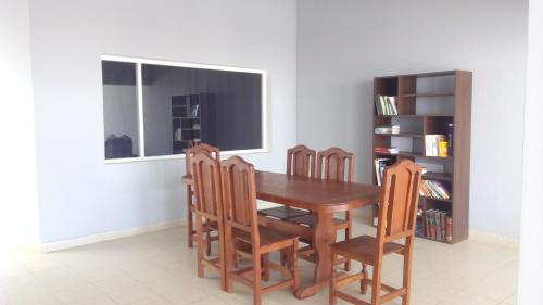 a dining room table with chairs and a window at Buen Descanso in Salta