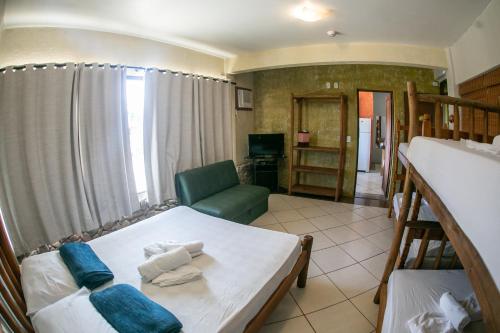 a living room with a white table and a couch at Pousada Pé na Areia in Garopaba
