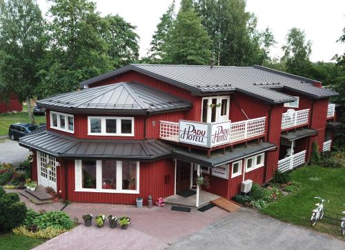 a red building with a sign for a dog hotel at Padu Hotell in Kärdla