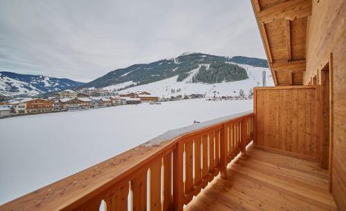 a balcony with a view of a snow covered mountain at Hotel Hubertushof in Saalbach Hinterglemm