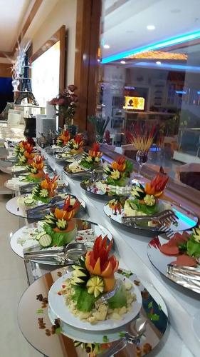 a row of plates of food on a table at Demosan Hotel in Karaman