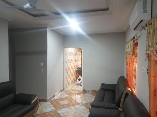 a living room with two couches and a light on the ceiling at Private Executive Apartments in Accra