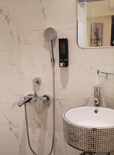 a bathroom with a shower and a sink at Hotel surya dev residency in Bengaluru