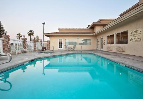 a large blue swimming pool in front of a building at Holiday Inn Express Corning by IHG in Corning