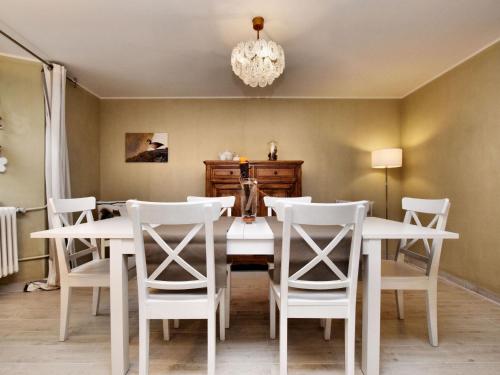 a dining room with a white table and chairs at Spacious holiday home in Ouren with infrared sauna in Burg-Reuland