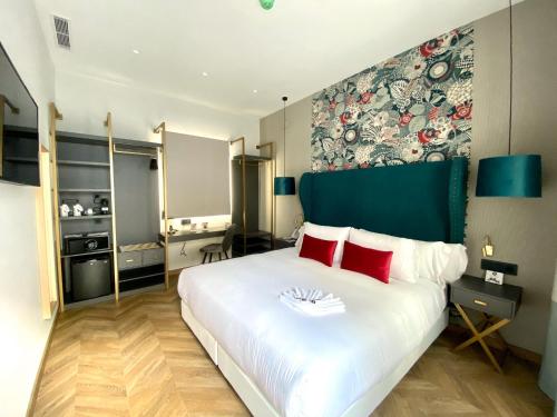 a bedroom with a large white bed with red pillows at Soho Boutique Sevilla in Seville