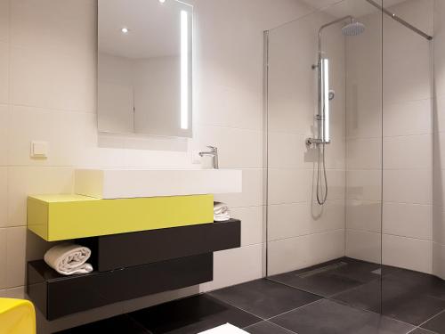 a bathroom with a sink and a shower at Semmering Loft in Semmering