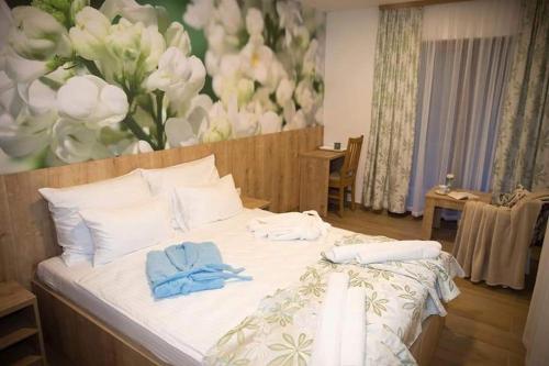 a bedroom with a bed with towels on it at Villa Bunski biser in Blagaj