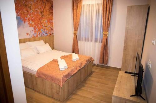 a bedroom with a bed with two towels on it at Villa Bunski biser in Blagaj