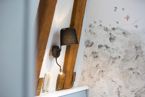 a phone hanging on a wall next to a wall at Hôtel Tourmalet in Luz-Saint-Sauveur