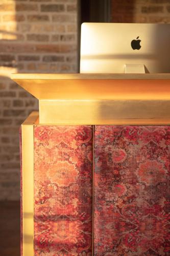 an apple laptop computer sitting on top of a book at The Mayson in Dublin