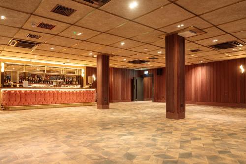 a large room with a bar in a building at The Mayson in Dublin