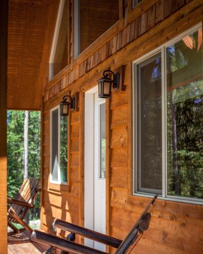 a front door of a log cabin with windows at The Ridge At Glacier - Luxury Cabins in Coram