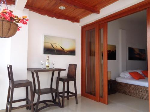 a room with a table and chairs and a bed at Terrazas de San Agustin Hotel in San Agustín