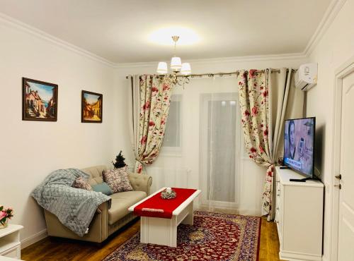 a living room with a couch and a red table at A&C Hotel Rooms - Up in the Sky in Oradea