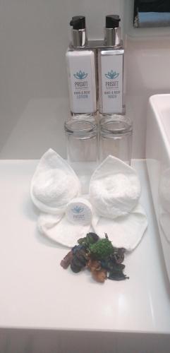 a white counter with two bottles of soap and some food at Prisatt Boutique Hotel in Onverwacht