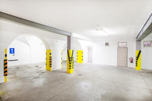 an empty room with yellow and black poles in it at Hotel U Tří hrušek suites & apartments in České Budějovice