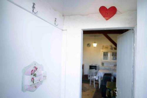 a room with a heart hanging on the wall at Apartments Holiday Home Srce in Kopaonik