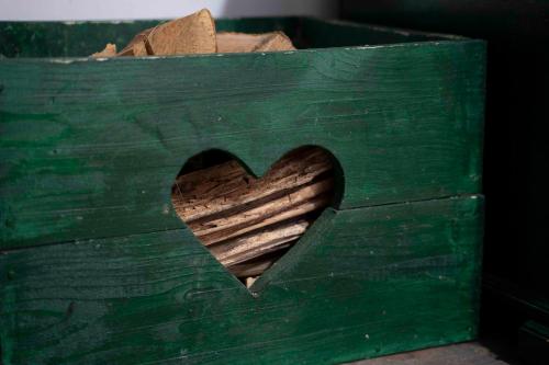 a wooden box with a heart cut out of it at Apartments Holiday Home Srce in Kopaonik