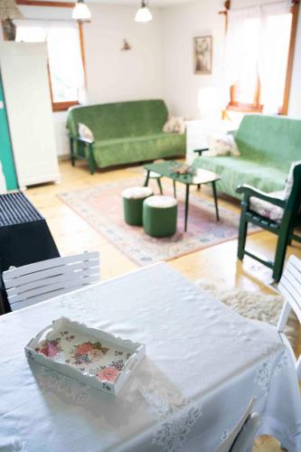 a living room with a table with a cake on it at Apartments Holiday Home Srce in Kopaonik