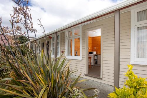 an exterior view of a house with plants at Wellington TOP 10 Holiday Park in Lower Hutt