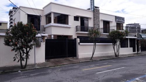 a white building on the side of a street at Hostal Santa María Gracia in Quito