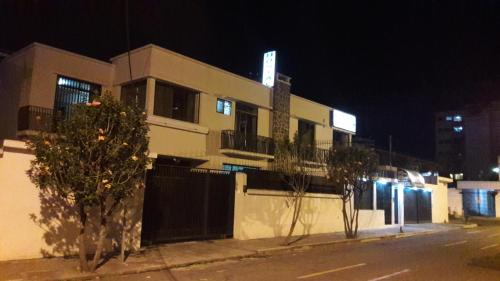 a building on the side of a street at night at Hostal Santa María Gracia in Quito