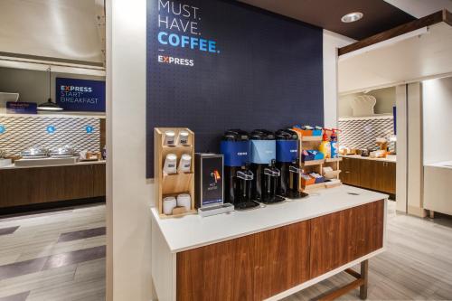 a coffee shop with bottles of coffee on a counter at Holiday Inn Express Hotel & Suites Murray by IHG in Murray