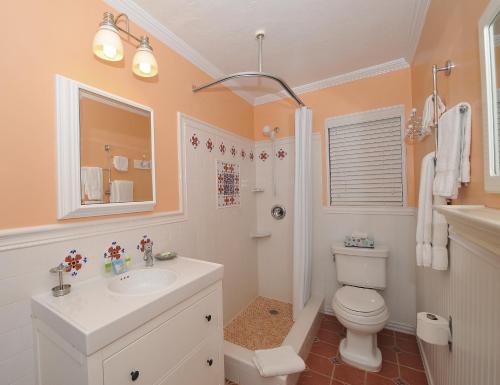 a bathroom with a white toilet and a sink at Blue Seas Courtyard in Fort Lauderdale