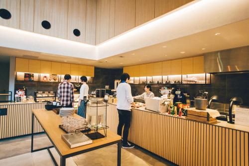 a group of people preparing food in a kitchen at BEB5 Karuizawa by Hoshino Resorts in Karuizawa