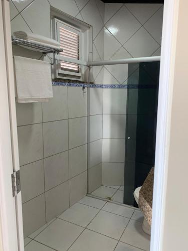 a shower with a glass door in a bathroom at Pousada Litorânea in São Luís