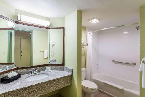 a bathroom with a sink and a toilet and a mirror at Quality Inn Payson in Payson
