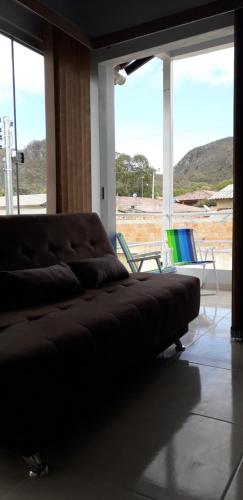 a living room with a couch and two chairs at Chalés Aconchego in Cavalcante