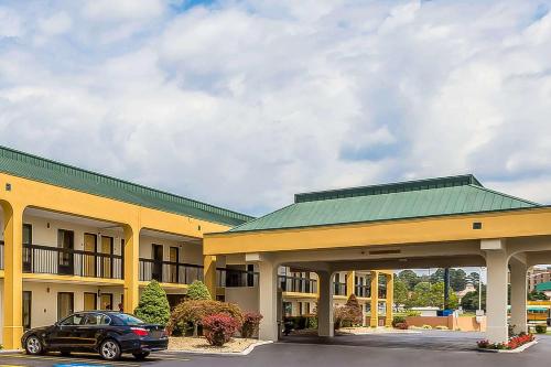 a car parked in front of a large building at Rodeway Inn Knoxville East in Knoxville