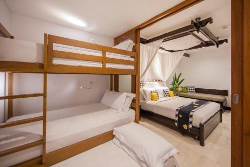 a bedroom with two bunk beds and a couch at Legian Beach Hotel in Legian