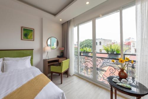 a hotel room with a bed and a balcony at AMI Old Quarter Hotel in Hanoi