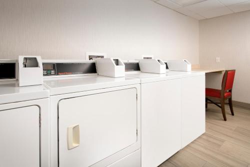 a row of white appliances on a counter in a room at Holiday Inn Express & Suites Baltimore - BWI Airport North by IHG in Linthicum Heights