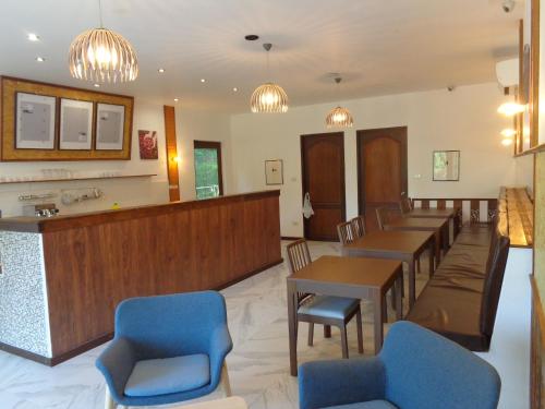 a waiting room at a hospital with tables and chairs at The Hillside Pranburi Resort in Pran Buri