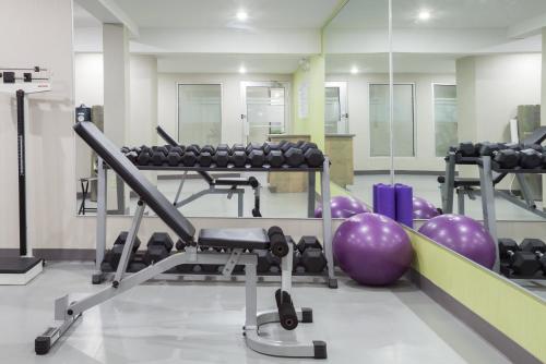 a gym with a bunch of balls and machines at Holiday Inn Express Hotel & Suites Uptown Fredericton by IHG in Fredericton