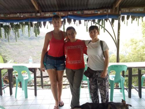 a group of three people posing for a picture at BATAD Rita's Mount View Inn and Restaurant in Banaue
